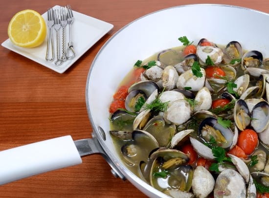 Steamer clams with tomato, garlic, lemon, dill, and parsley