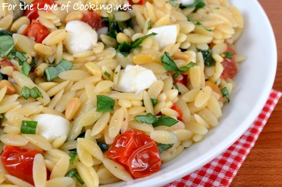 Orzo with Sautéed Garlicky Spinach and Tomatoes topped with Mozzarella and Toasted Pine Nuts