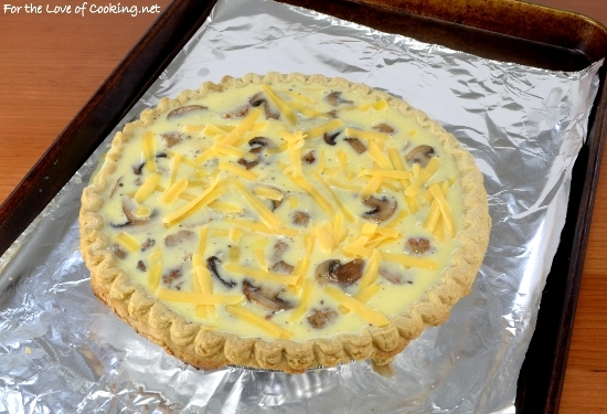 Add the well whisked egg mixture. Sprinkle the remaining sausage, mushrooms, and cheese on top.